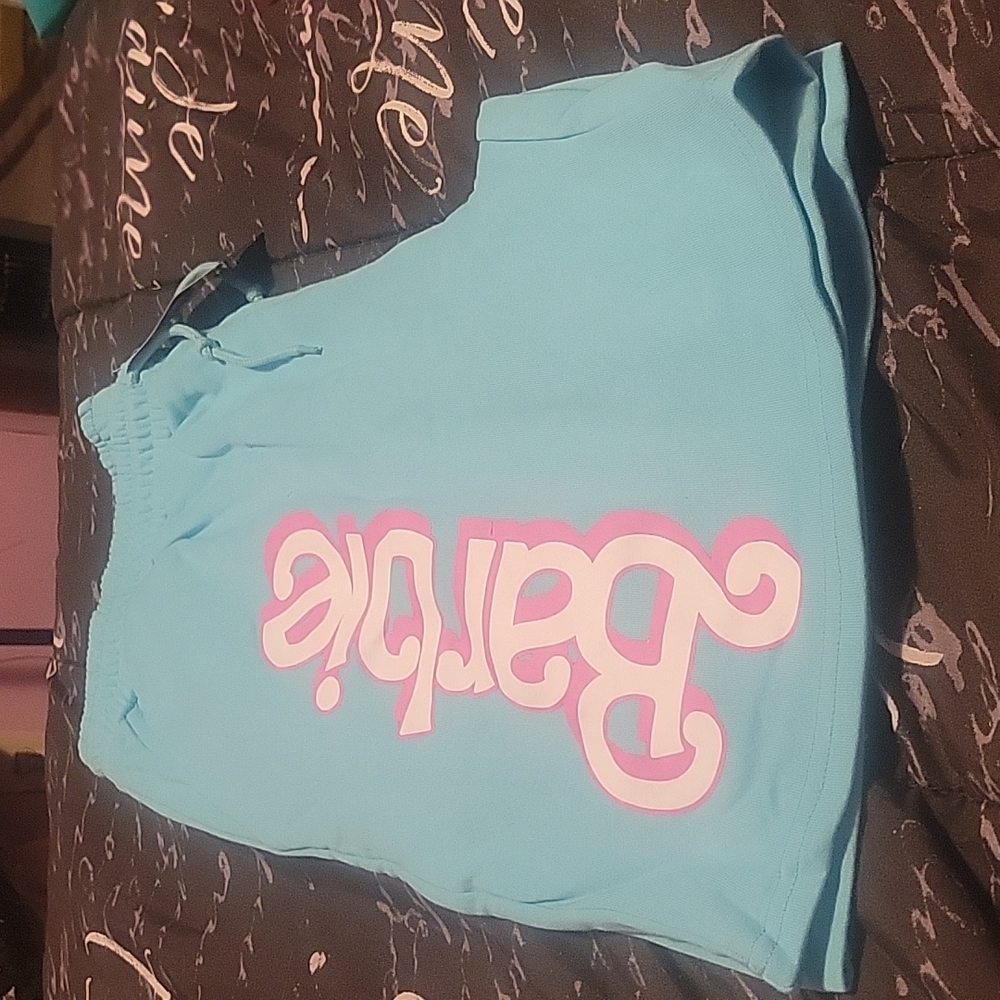 Blue shorts with barbie on them